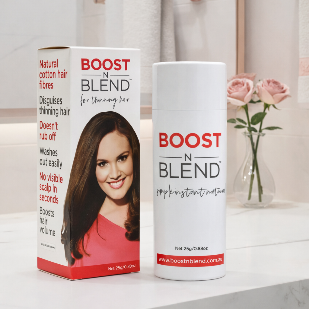 Boost n Blend hair fibres product packaging on a bathroom counter with flowers in the background