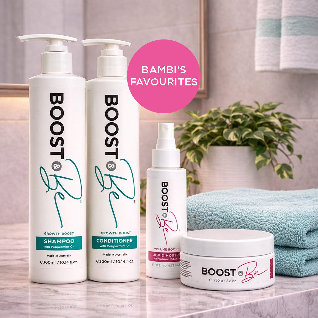 Boost & Be hair care products on a bathroom counter with a plant and towel in the background.